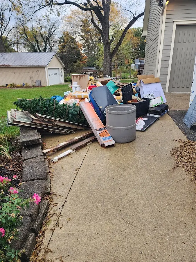 Dumpster being loaded with debris for Estate Cleanout Dumpster Rental in Belmont